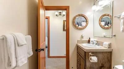 a bathroom with a sink and a mirror at Minutes to Skiing Lake Hot Tub Fire Pit Deck Indigo Owl by AvantStay in Homewood