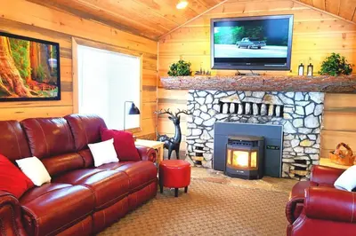 a living room with a couch and a fireplace at Sequoia Splendor, inside Kings Canyon NP by Visitors Center in Wilsonia