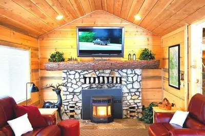a living room with a fireplace with a tv on top at Sequoia Splendor, inside Kings Canyon NP by Visitors Center in Wilsonia
