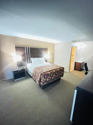 a hotel room with a bed and two lamps at Star Inn in Tonopah