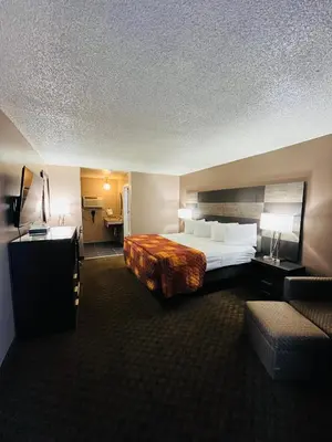 a hotel room with a large bed and a couch at Star Inn in Tonopah