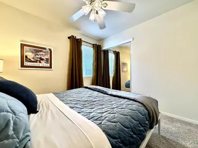 a bedroom with a bed and a ceiling fan at King Bed Retreat, Pet-Friendly, Rancho Cordova in Rancho Cordova