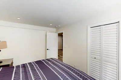 a bedroom with a bed and a white wall at Forest Grove in Kings Beach