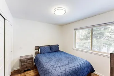 a bedroom with a bed and a window at Forest Grove in Kings Beach