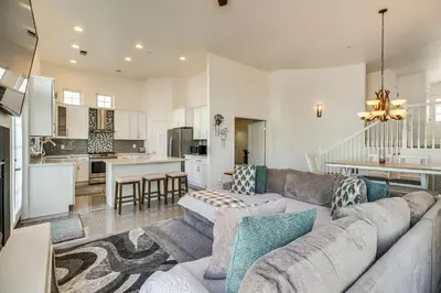a living room with a couch and a kitchen at Theater Room, Fireplace Home 5 Mi to Dtwn Reno! in Sparks
