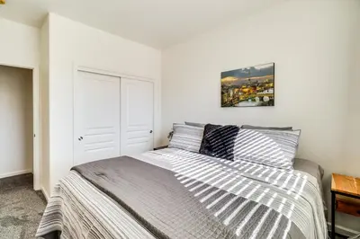 a bedroom with a bed and a picture on the wall at Theater Room, Fireplace Home 5 Mi to Dtwn Reno! in Sparks