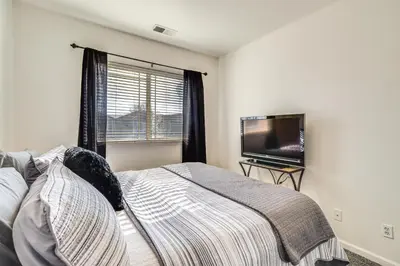 a bedroom with a bed and a flat screen tv at Theater Room, Fireplace Home 5 Mi to Dtwn Reno! in Sparks
