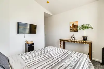 a bedroom with a bed and a tv on the wall at Theater Room, Fireplace Home 5 Mi to Dtwn Reno! in Sparks