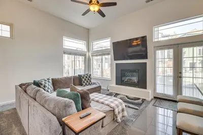 a living room with a couch and a tv at Theater Room, Fireplace Home 5 Mi to Dtwn Reno! in Sparks