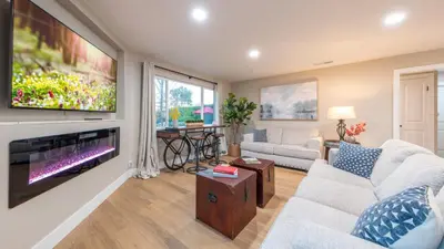 a living room with a large flat screen tv at Folsom Old Town Escape in Folsom