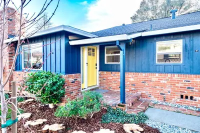 a blue house with a yellow door at Folsom Old Town Escape in Folsom