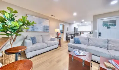 a living room with two couches and a table at Folsom Old Town Escape in Folsom