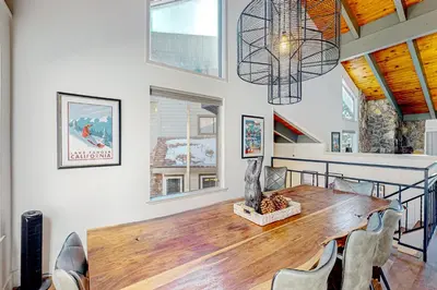a dining room with a wooden table and chairs at Making Waves, Unit B in Stateline