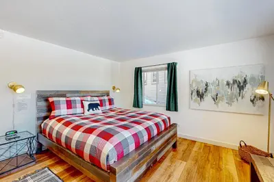 a bedroom with a bed with a plaid blanket at Making Waves, Unit B in Stateline