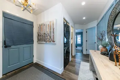 a hallway with a blue door in a house at Stylish 2BD Condo - Walk to Palisades! in Olympic Valley