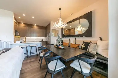a dining room and kitchen with a table and chairs at Stylish 2BD Condo - Walk to Palisades! in Olympic Valley