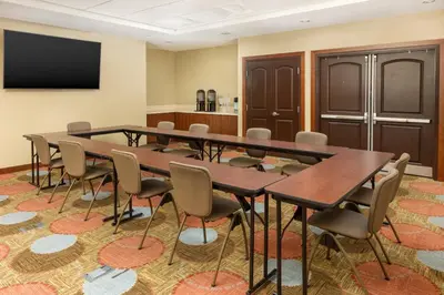 a conference room with a large table and chairs at Staybridge Suites Sacramento-Folsom by IHG in Folsom