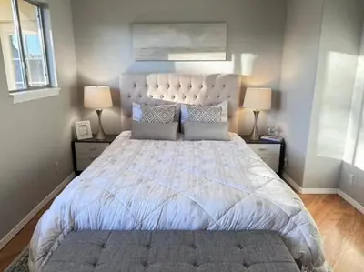 a bedroom with a large white bed with two lamps at Ripon Orchard Retreat in Ripon