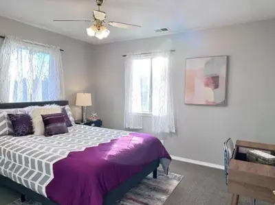 a bedroom with a bed and a ceiling fan at Ripon Orchard Retreat in Ripon