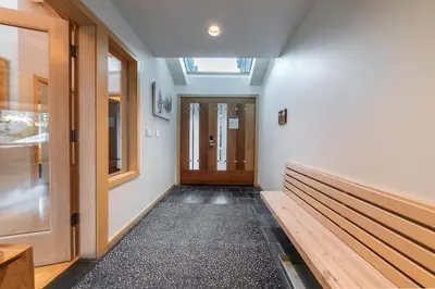 a hallway with benches and a wooden door at Bright 5BD Alpine Retreat - 5Min to Alpine Meadows in Tahoe City