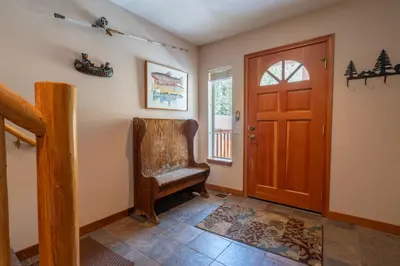 a hallway with a chair and a door at Hideaway Down Canyon #101 in June Lake