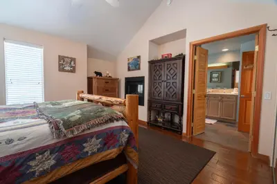 a bedroom with a bed and a bathroom at Hideaway Down Canyon #101 in June Lake