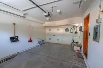 an empty room with a large concrete floor and white walls at Hideaway Down Canyon #101 in June Lake