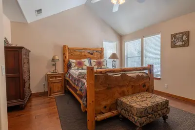 a bedroom with a bed with a wooden bed frame at Hideaway Down Canyon #101 in June Lake
