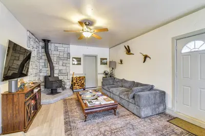 a living room with a couch and a tv at Lake Access and Hot Tub Pet-Friendly Arnold Home in Arnold
