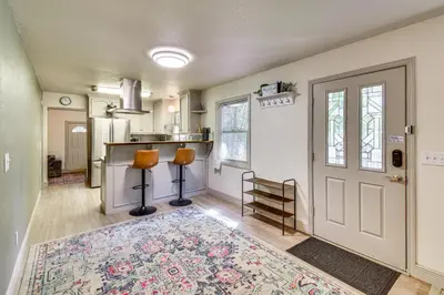 a living room with a kitchen and a door at Lake Access and Hot Tub Pet-Friendly Arnold Home in Arnold