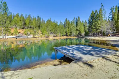 a picnic table in the middle of a lake at Lake Access and Hot Tub Pet-Friendly Arnold Home in Arnold