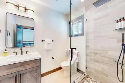 a bathroom with a toilet and a glass shower at Mountain Majesty in Truckee