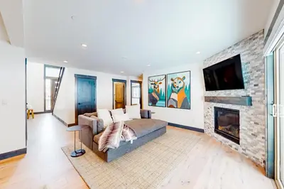 a living room with a couch and a fireplace at Mountain Majesty in Truckee
