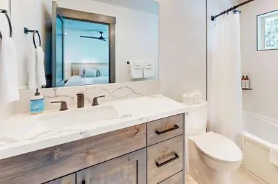 a white bathroom with a sink and a toilet at Mountain Majesty in Truckee