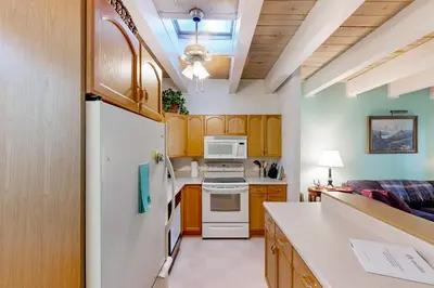 a kitchen with wooden cabinets and a white refrigerator at Take a Peak in Incline Village