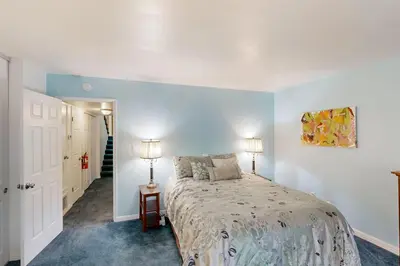 a bedroom with a bed and two lamps on a table at Take a Peak in Incline Village