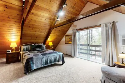 a bedroom with a bed and a large window at Cardinal's Nest in Groveland