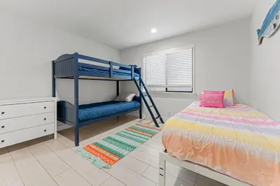 a bedroom with a bunk bed and a blue bed at * Large Updated Waterfront Delta Manor Boat Dock * in Discovery Bay