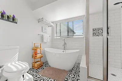a white bathroom with a tub and a toilet at * Large Updated Waterfront Delta Manor Boat Dock * in Discovery Bay