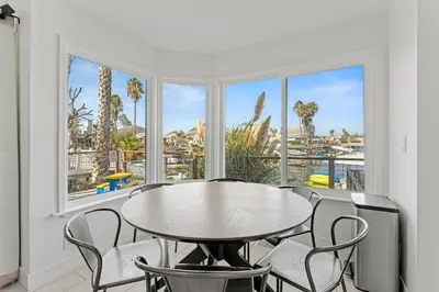 a dining room with a table and chairs and windows at * Large Updated Waterfront Delta Manor Boat Dock * in Discovery Bay