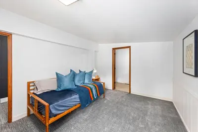 a bedroom with a bed with blue pillows at Sunnyside Retreat - Tahoe City, 4 BR, Pet Friendly, Bonus Room in Tahoe City