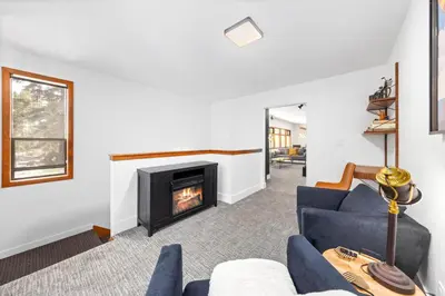 a living room with a blue couch and a fireplace at Sunnyside Retreat - Tahoe City, 4 BR, Pet Friendly, Bonus Room in Tahoe City
