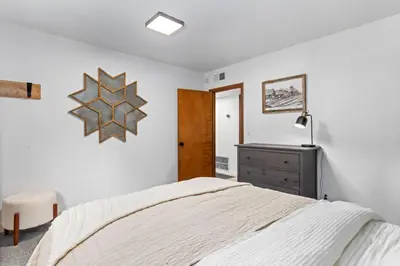 a bedroom with a bed and a clock on the wall at Sunnyside Retreat - Tahoe City, 4 BR, Pet Friendly, Bonus Room in Tahoe City