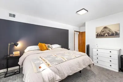 a bedroom with a large bed with a black accent wall at Sunnyside Retreat - Tahoe City, 4 BR, Pet Friendly, Bonus Room in Tahoe City