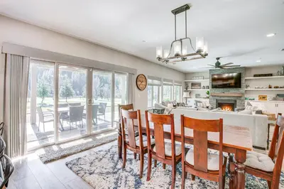 a kitchen and dining room with a table and chairs at Game Room and Pool Access Spacious Cabin in Arnold in Arnold