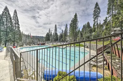 a view of a swimming pool from a balcony at Game Room and Pool Access Spacious Cabin in Arnold in Arnold