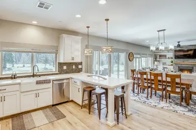a kitchen with a large island and a dining room at Game Room and Pool Access Spacious Cabin in Arnold in Arnold