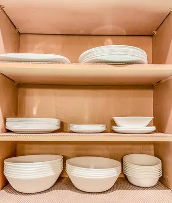 a shelf filled with white plates and bowls at Pickleball Retreat near Bass Lake & S. Yosemite in Ahwahnee
