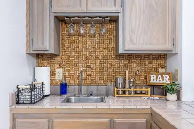 a kitchen counter with a sink and a bar sign at WHouse*HotTub*Sleeps20*BLS*FirePit*AC&Heat*DogsOk in Arnold