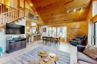 a living room and dining room in a log cabin at Hot Tub Hideaway in Dorrington